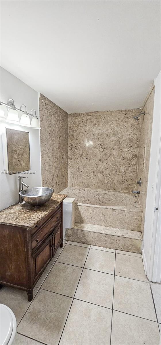 11 Crossings Circle, Unit C Boynton Beach, FL 33435 - Photo 15 of 20 a bathroom with a granite countertop sink a toilet and bathtub