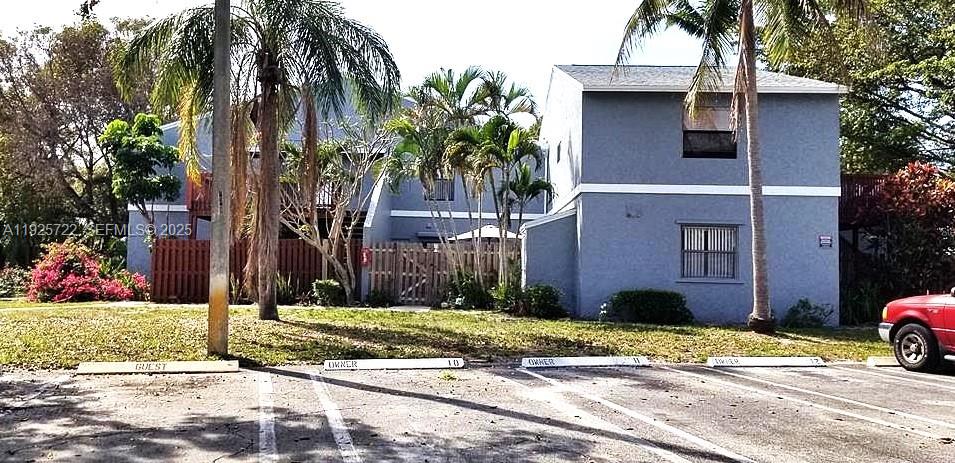 11 Crossings Circle, Unit C Boynton Beach, FL 33435 - Photo 2 of 20 a front view of a house with a yard and palm trees