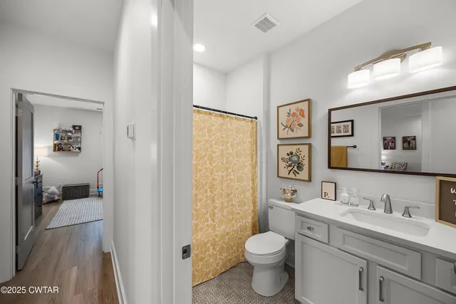 a bathroom with a toilet sink double vanity