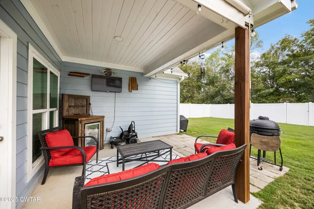 a view of a patio with a table chairs and a potted plant