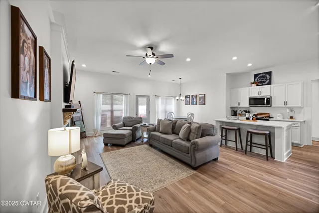 a living room with furniture and kitchen view