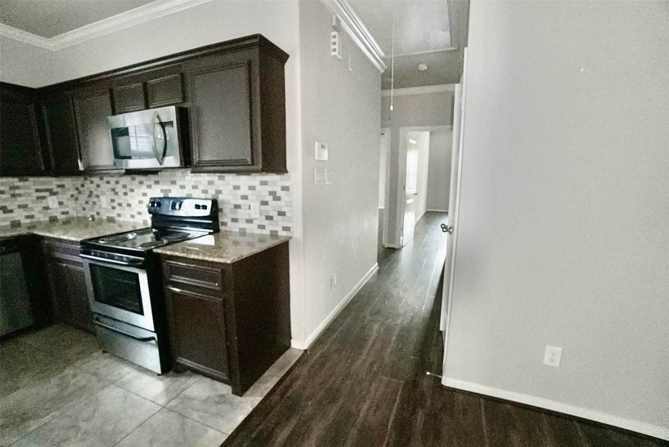 2523 Kirk Street, Unit B Houston, TX 77026 - Photo 6 of 16 a kitchen with granite countertop a stove and a sink