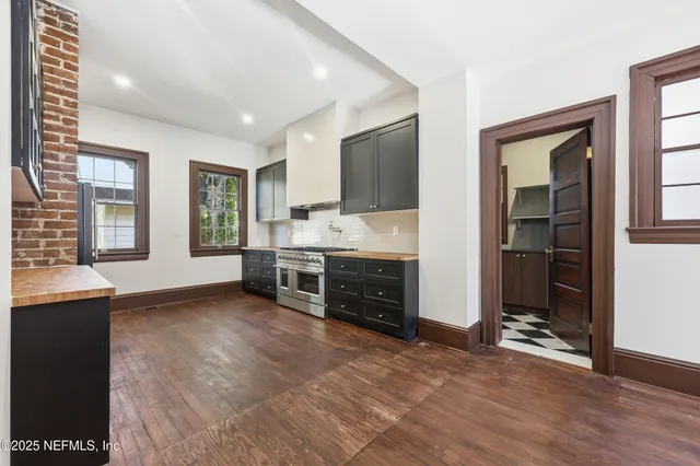 a view of a livingroom with furniture staircase and windows
