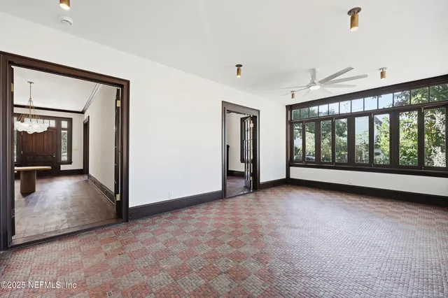 a view of big room with wooden floor and windows