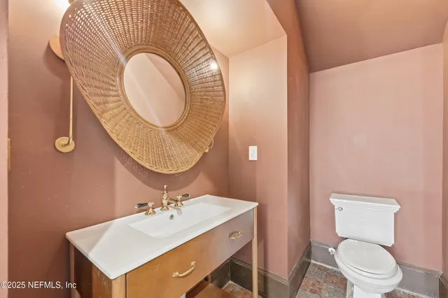 a view of a hallway with wooden floor and a room