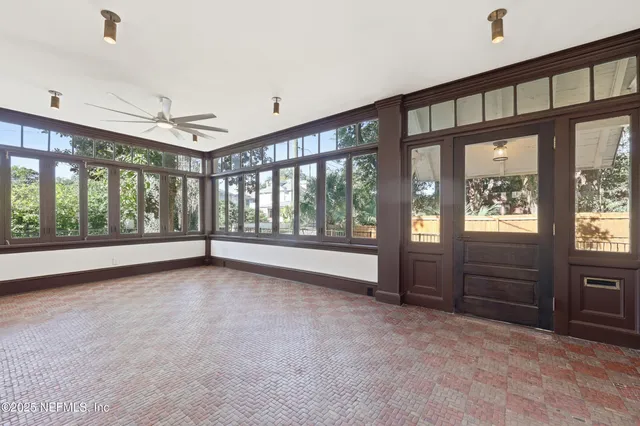 a view of a house with wooden fence and large windows