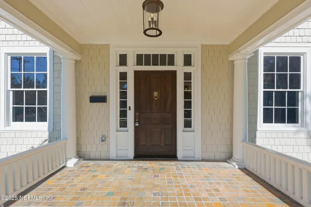 a view of a big room with wooden floor and windows