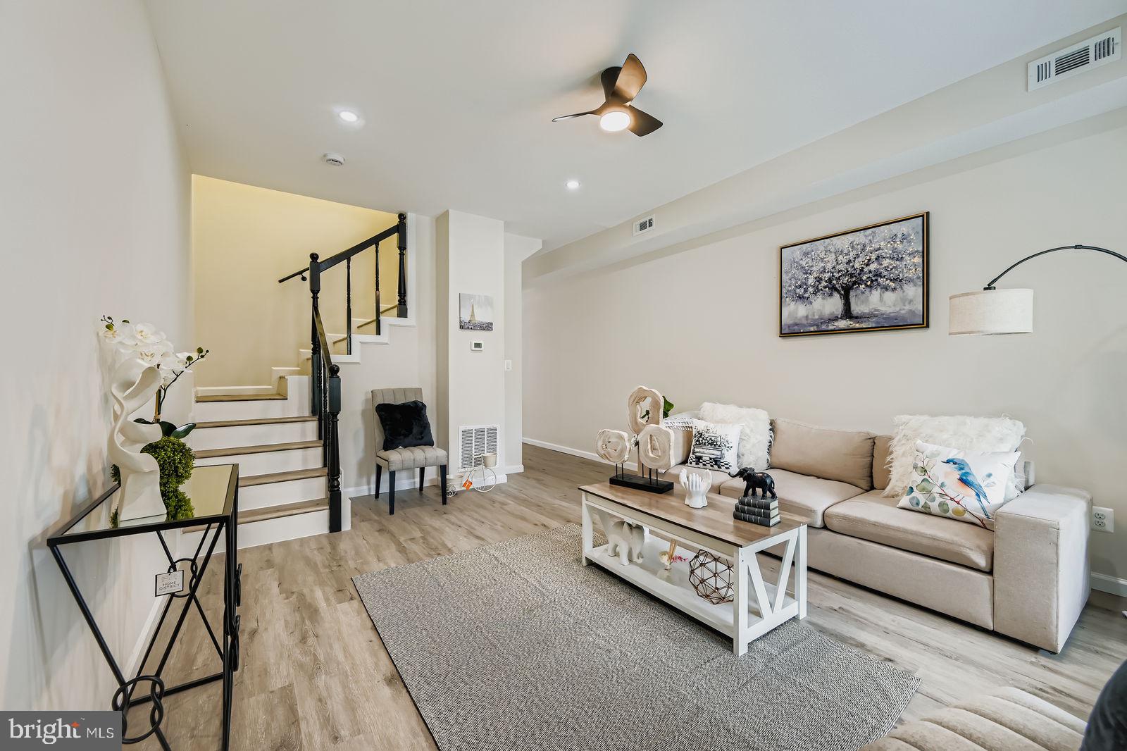 a living room with furniture and a wooden floor