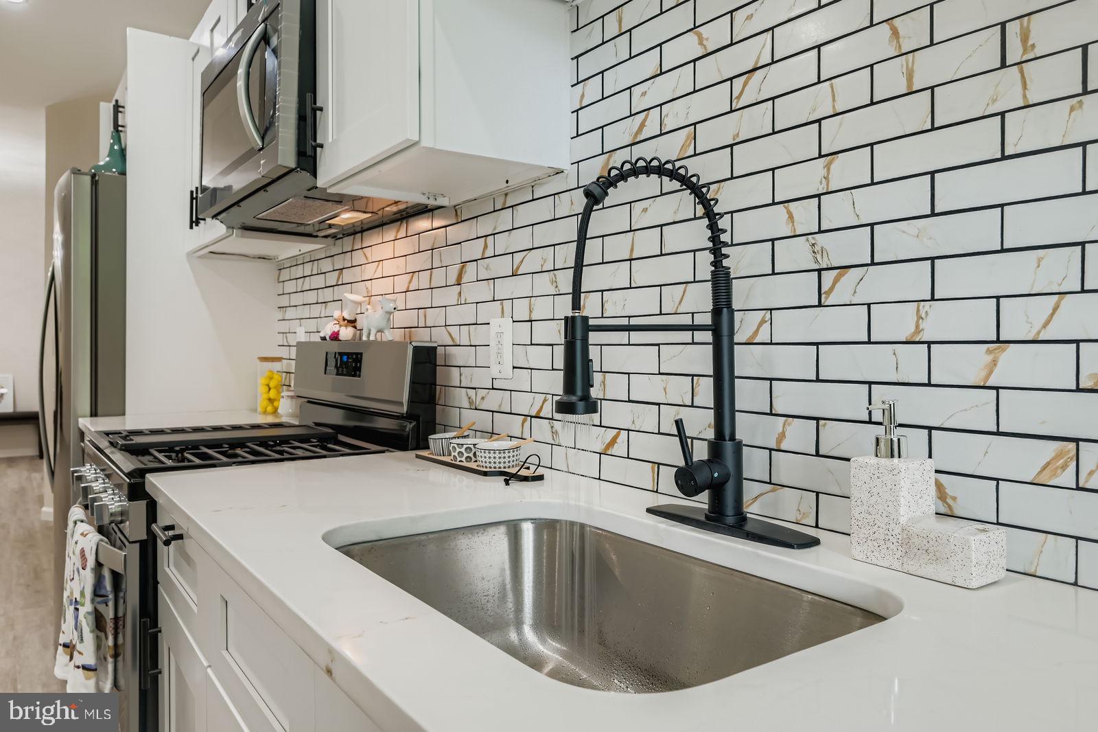 3429 Reisterstown Road Baltimore, MD 21215 - Photo 15 of 28 a kitchen with a sink and cabinets