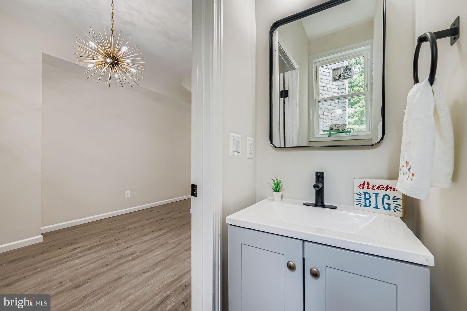 3429 Reisterstown Road Baltimore, MD 21215 - Photo 20 of 28 a bathroom with a sink and a mirror