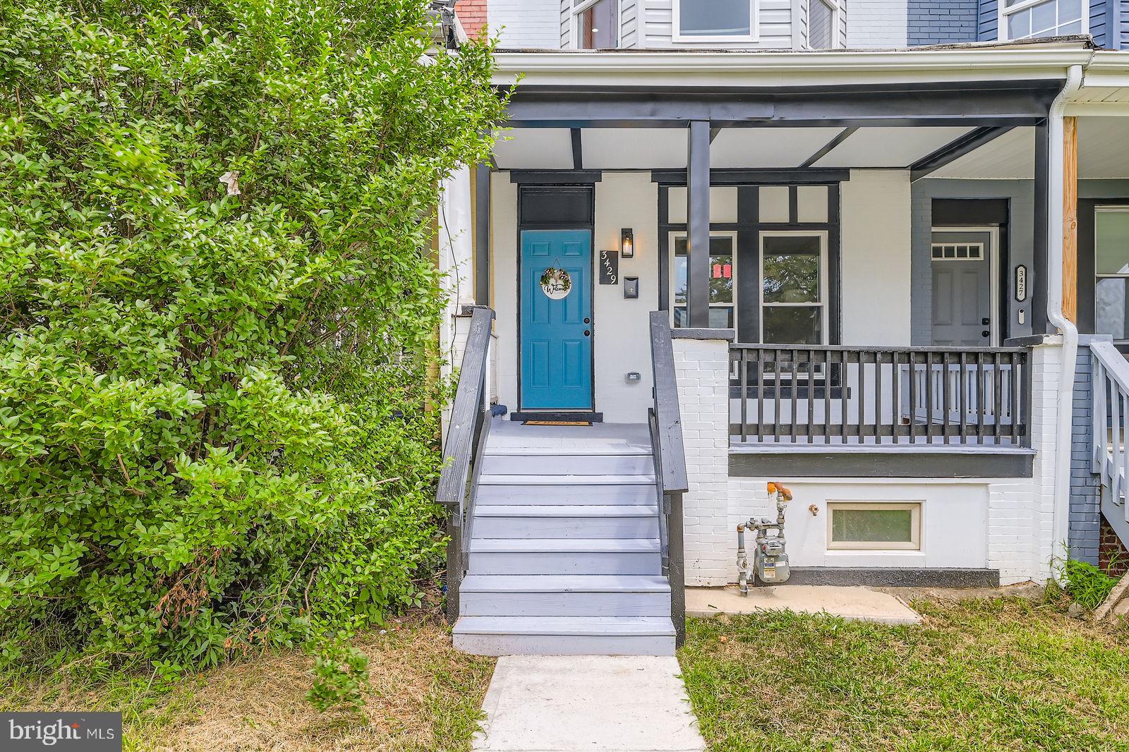 3429 Reisterstown Road Baltimore, MD 21215 - Photo 4 of 28 a front view of a house with a garden