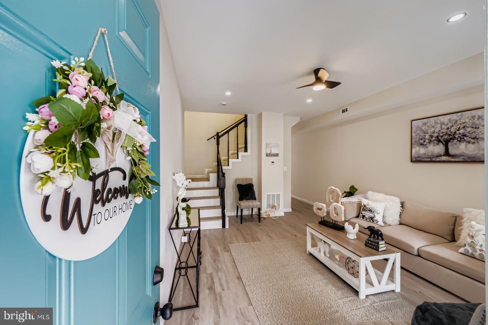 3429 Reisterstown Road Baltimore, MD 21215 - Photo 6 of 28 a living room with furniture flowers and flowers