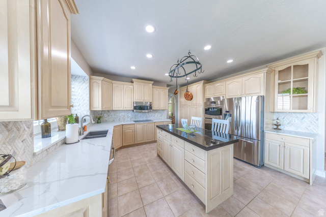 144 Bountiful Boulevard Bountiful, UT 84010 - Photo 11 of 28 Kitchen with light wood finish cabinets, stainless steel appliances, backsplash, quartz countertops, and recessed lighting