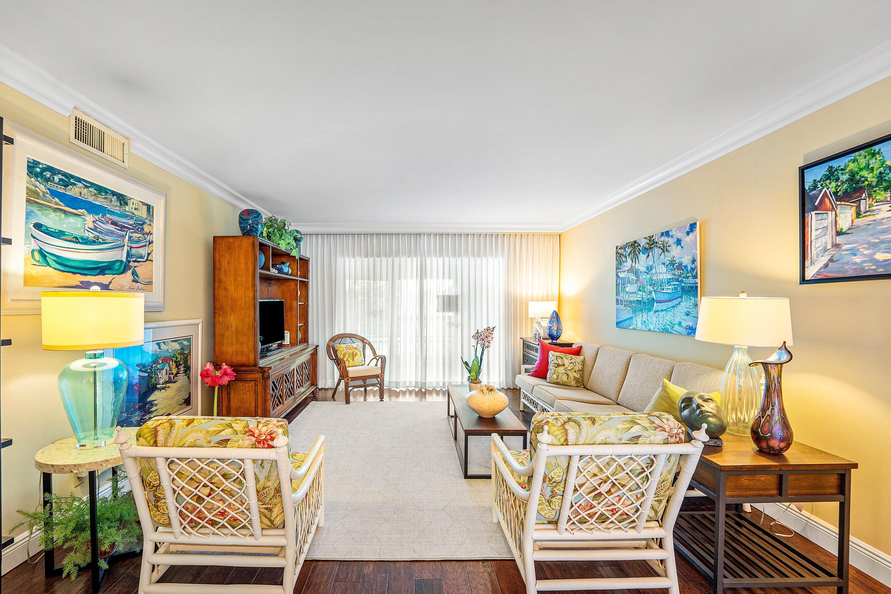 800 East Camino Real, Unit 409 Boca Raton, FL 33432 - Photo 12 of 37 a living room with furniture a flat screen tv and a window