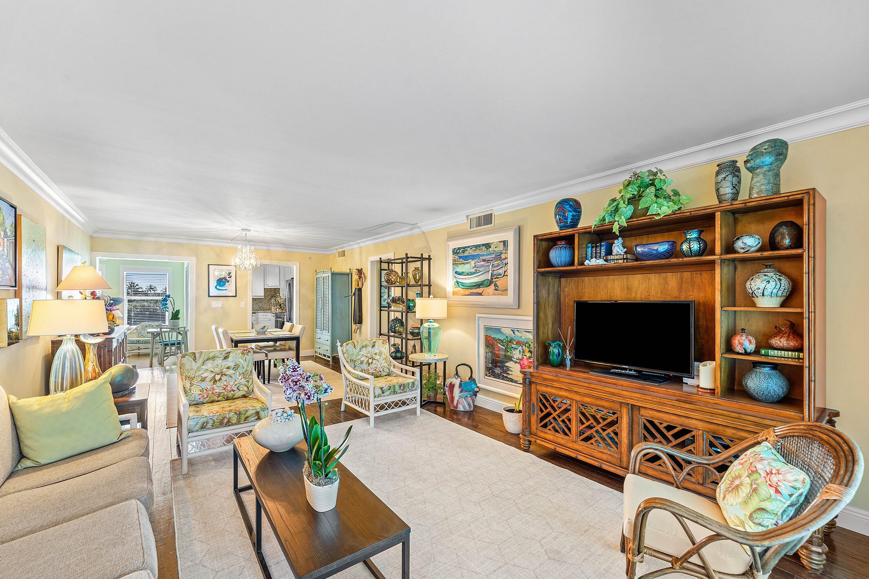 800 East Camino Real, Unit 409 Boca Raton, FL 33432 - Photo 14 of 37 a living room with furniture and a flat screen tv