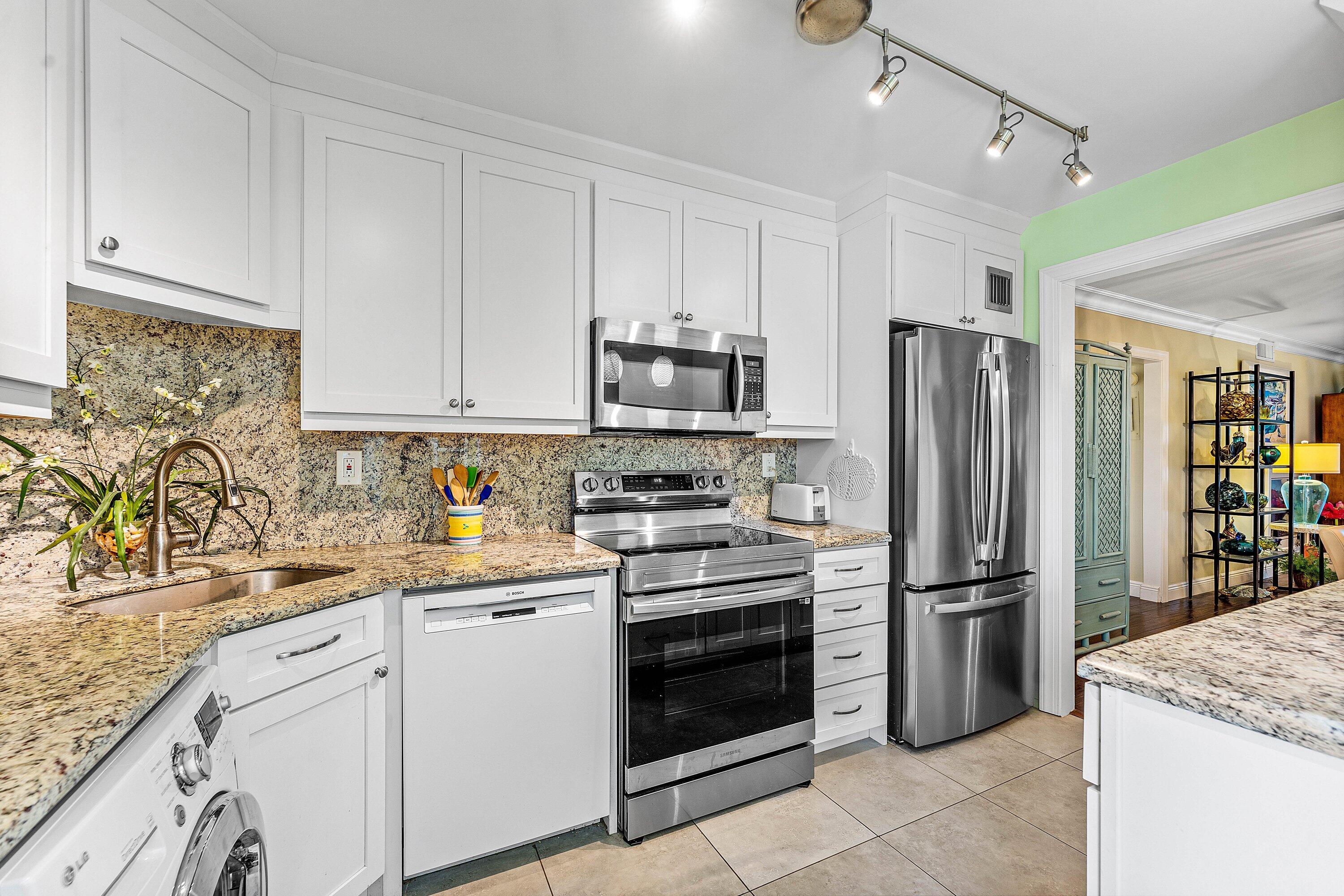 800 East Camino Real, Unit 409 Boca Raton, FL 33432 - Photo 17 of 37 a kitchen with a sink stove and refrigerator