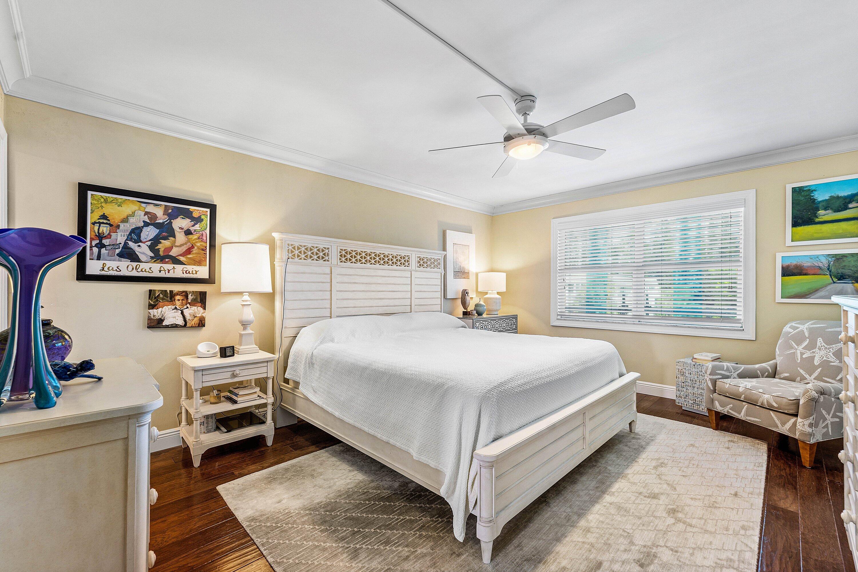 800 East Camino Real, Unit 409 Boca Raton, FL 33432 - Photo 20 of 37 a bedroom with a bed and a large window