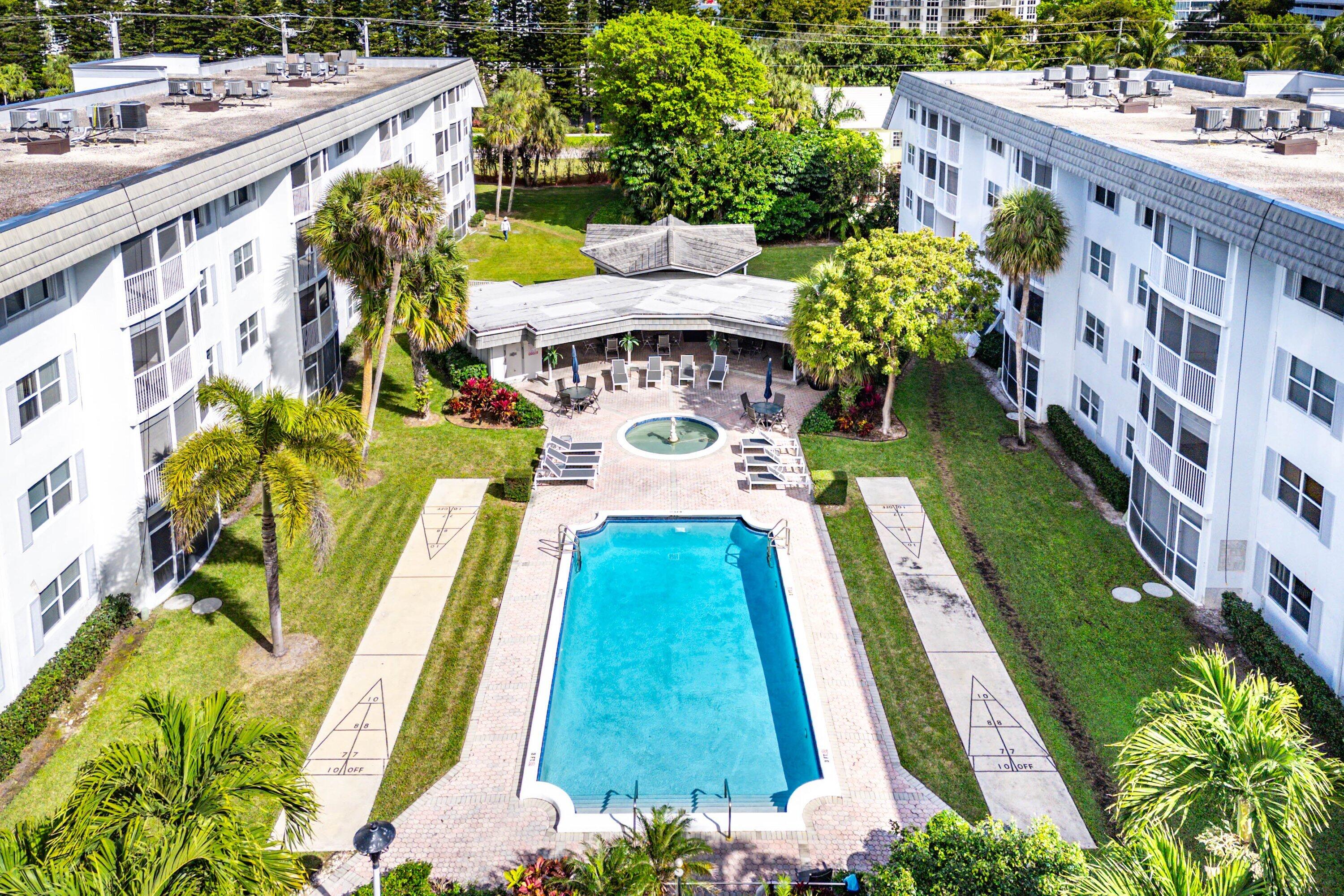 800 East Camino Real, Unit 409 Boca Raton, FL 33432 - Photo 27 of 37 a aerial view of a house with swimming pool lawn chairs and garden