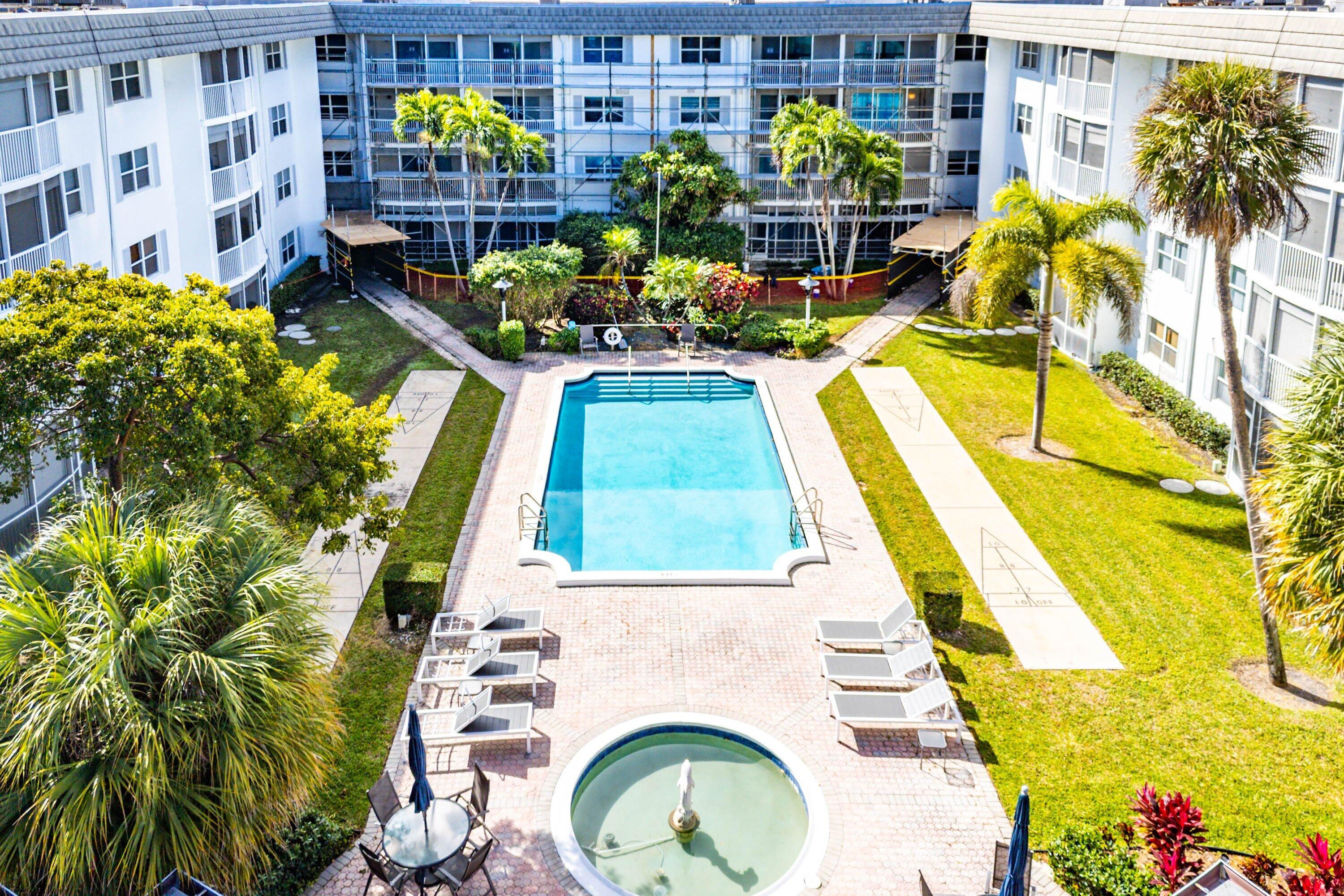 800 East Camino Real, Unit 409 Boca Raton, FL 33432 - Photo 28 of 37 a view of swimming pool with a patio