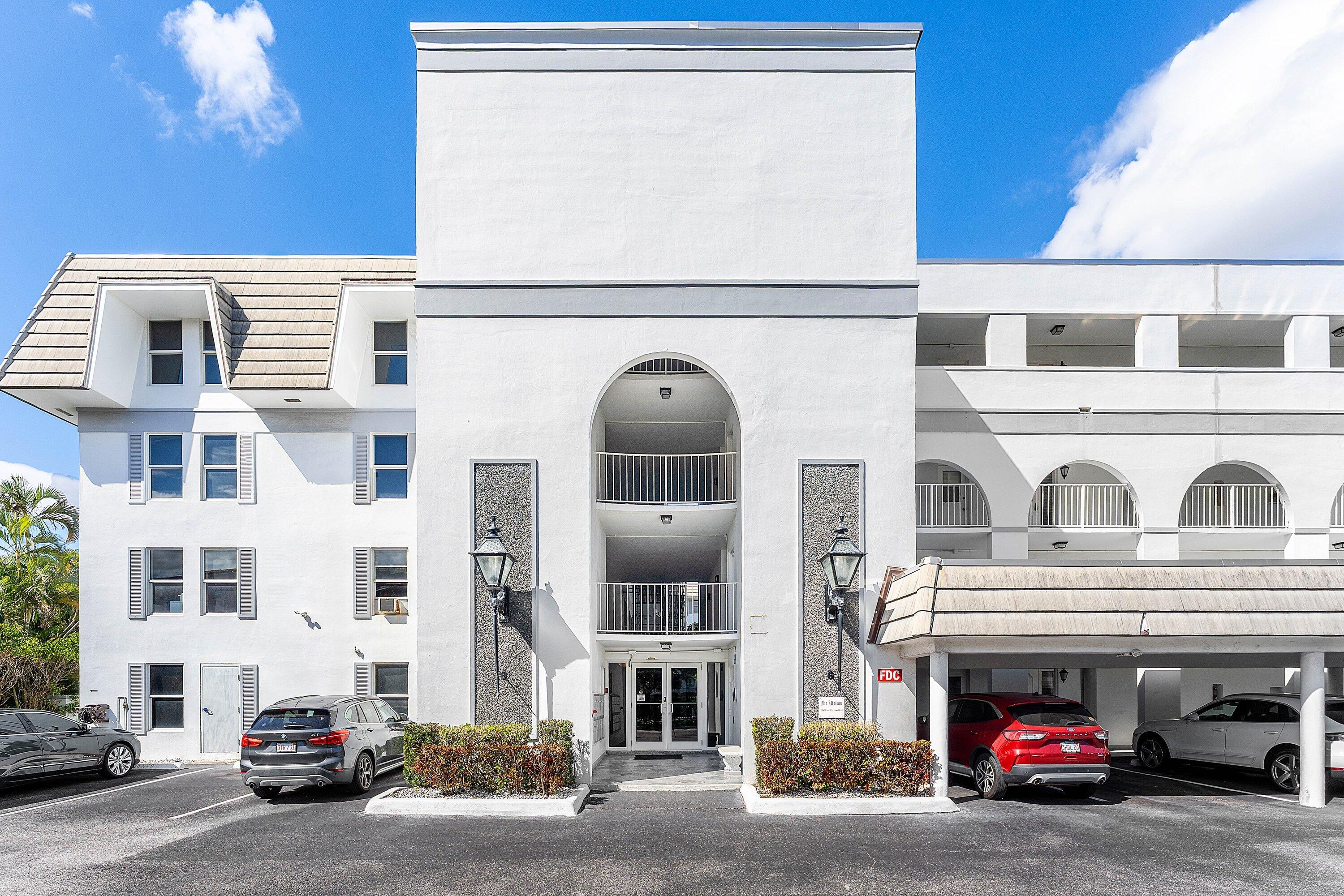 800 East Camino Real, Unit 409 Boca Raton, FL 33432 - Photo 4 of 37 a view of a car is parked in front of a building