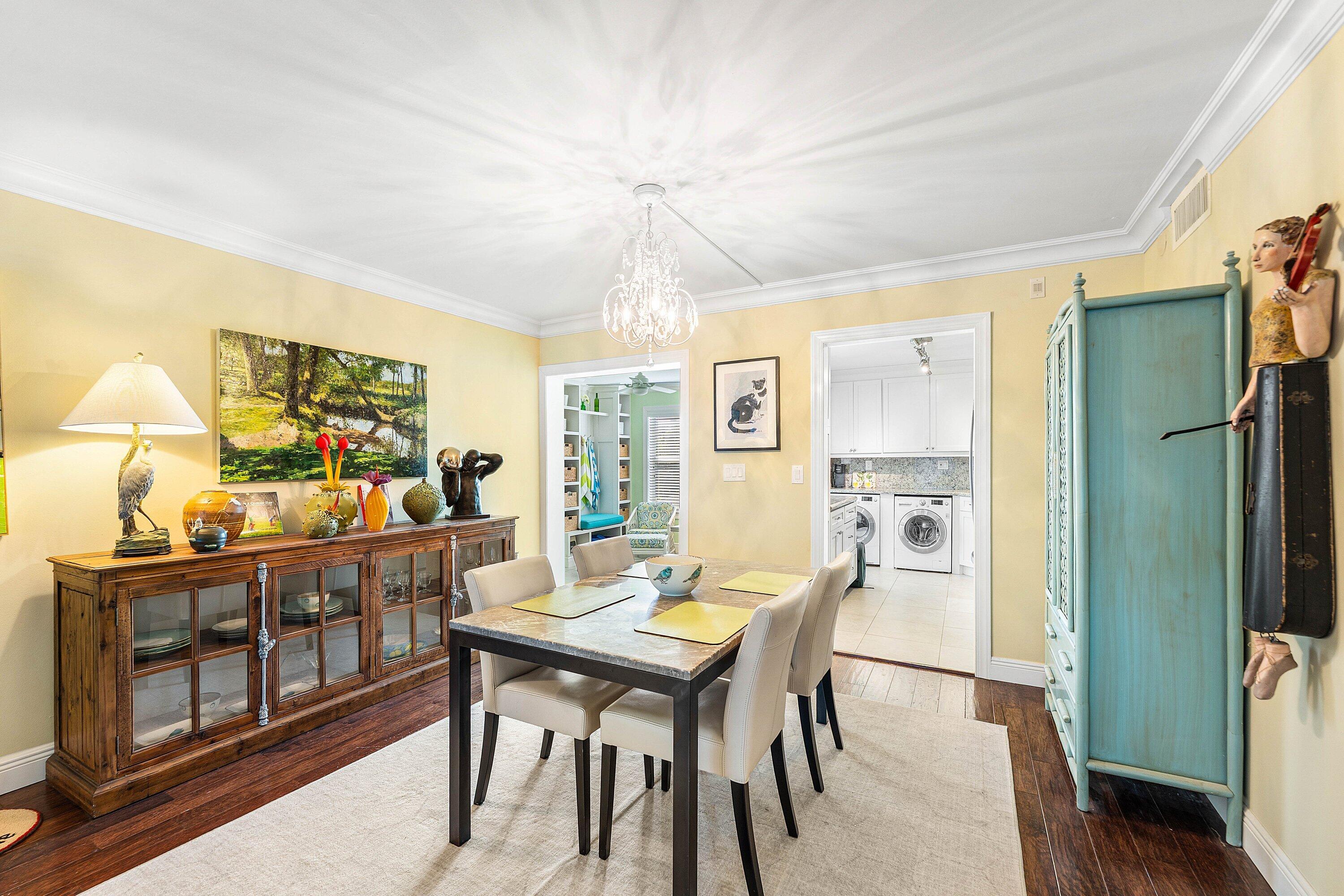 800 East Camino Real, Unit 409 Boca Raton, FL 33432 - Photo 9 of 37 a view of a dining room with furniture window and wooden floor