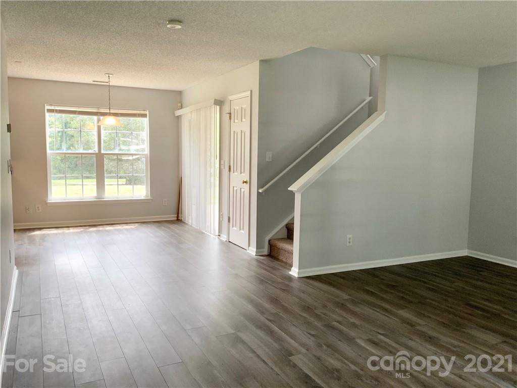 5136 Deerton Road Charlotte, NC 28269 - Photo 2 of 18 an empty room with wooden floor and windows