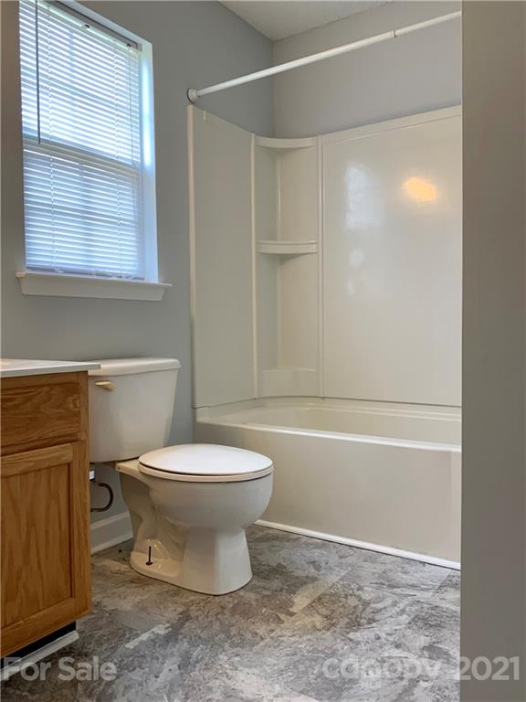 5136 Deerton Road Charlotte, NC 28269 - Photo 12 of 18 a bathroom with a toilet a sink and a shower