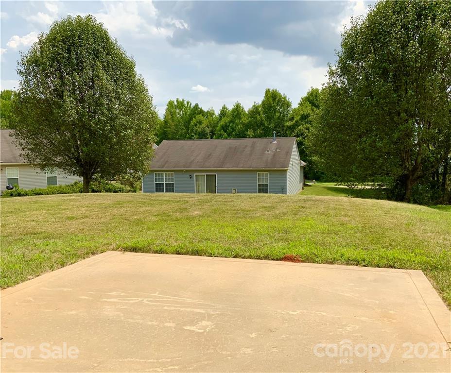 5136 Deerton Road Charlotte, NC 28269 - Photo 18 of 18 a house with green field in front of it