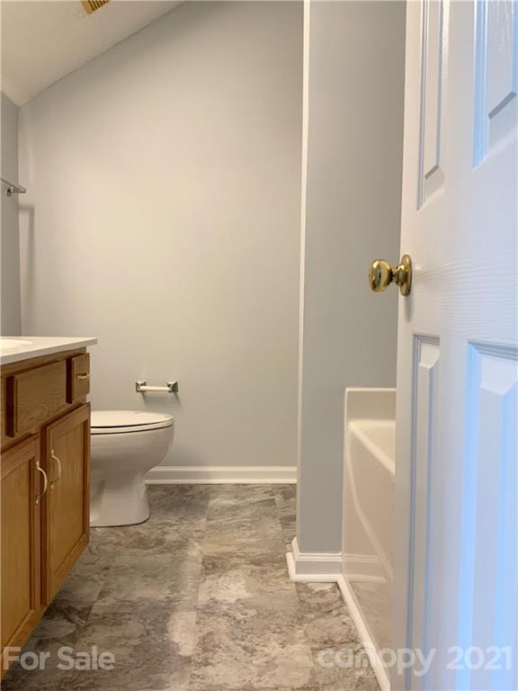 5136 Deerton Road Charlotte, NC 28269 - Photo 8 of 18 a bathroom with a toilet and a shower