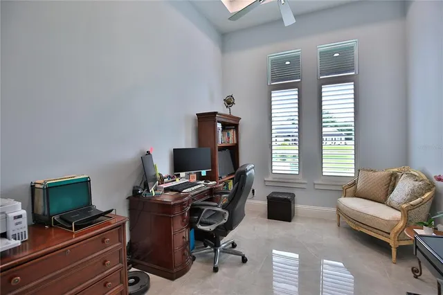 a livingroom with workspace and a window