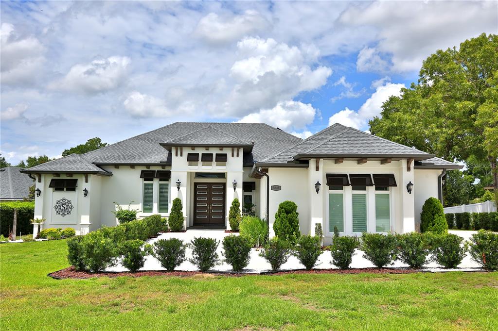 5845 Southwest 43rd St Road Ocala, FL 34474 - Photo 2 of 38 front view of a house with a yard