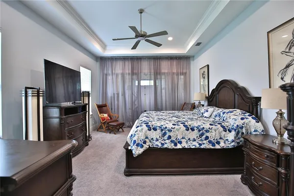 a bedroom with a bed and a television