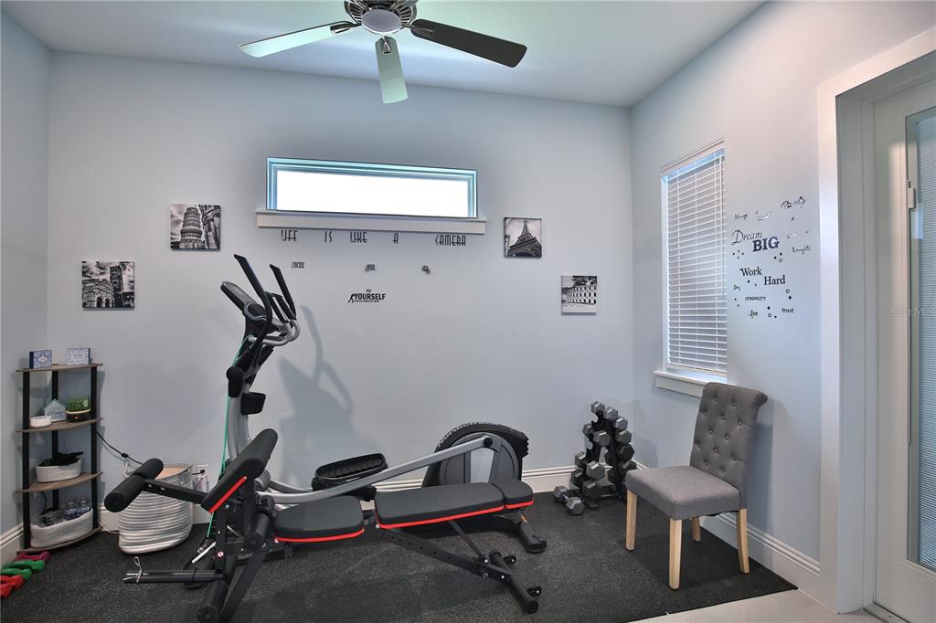 5845 Southwest 43rd St Road Ocala, FL 34474 - Photo 22 of 38 a room with gym equipment and a window