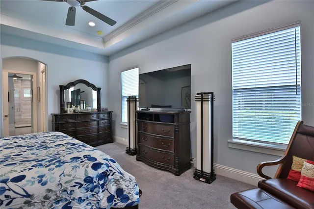 a bedroom with a bed and a television in it