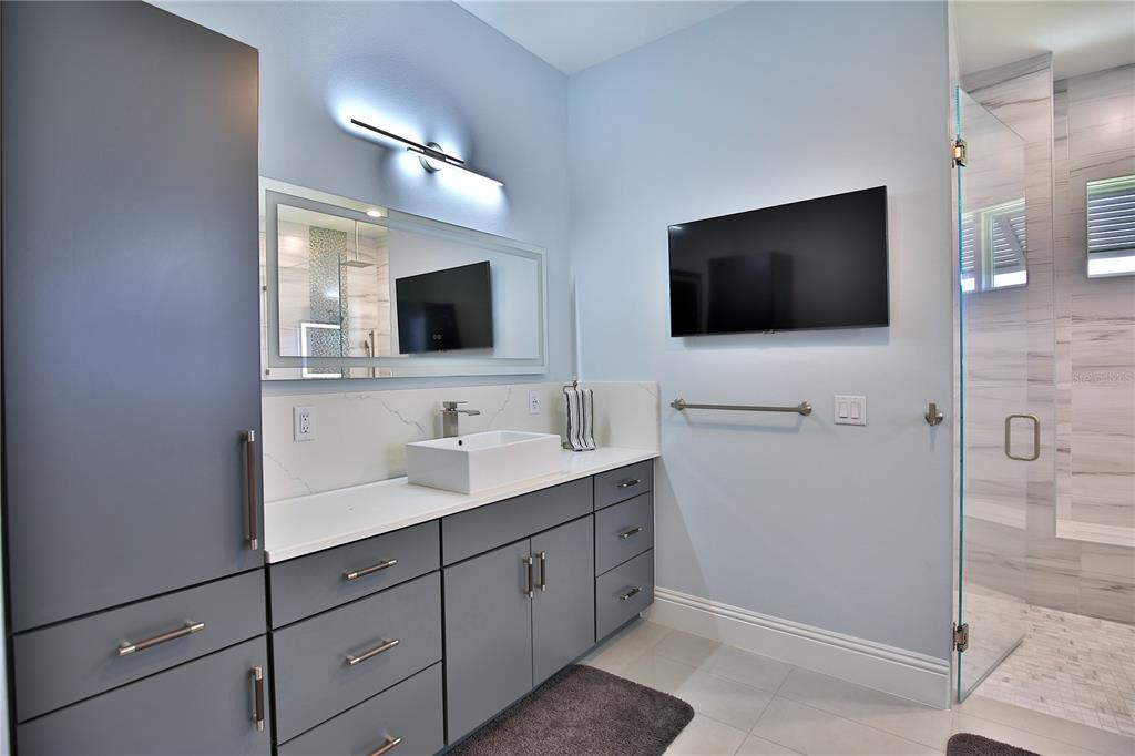 5845 Southwest 43rd St Road Ocala, FL 34474 - Photo 24 of 38 a spacious bathroom with a double vanity sink and a mirror