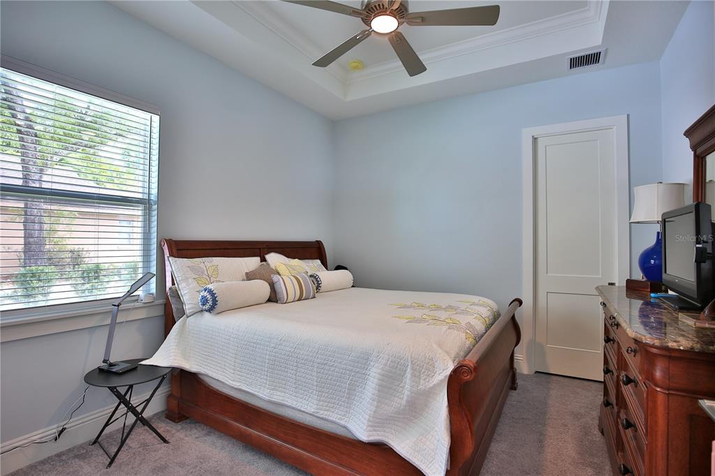 5845 Southwest 43rd St Road Ocala, FL 34474 - Photo 26 of 38 a bedroom with a bed window and a flat screen tv