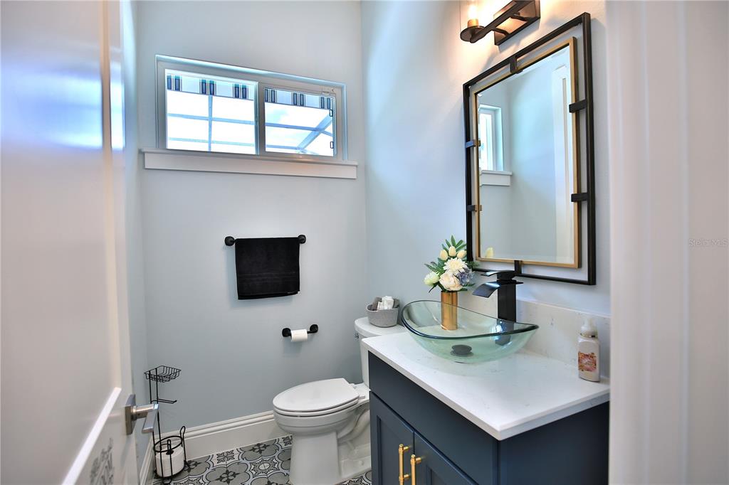 5845 Southwest 43rd St Road Ocala, FL 34474 - Photo 29 of 38 a bathroom with a sink vanity mirror and toilet