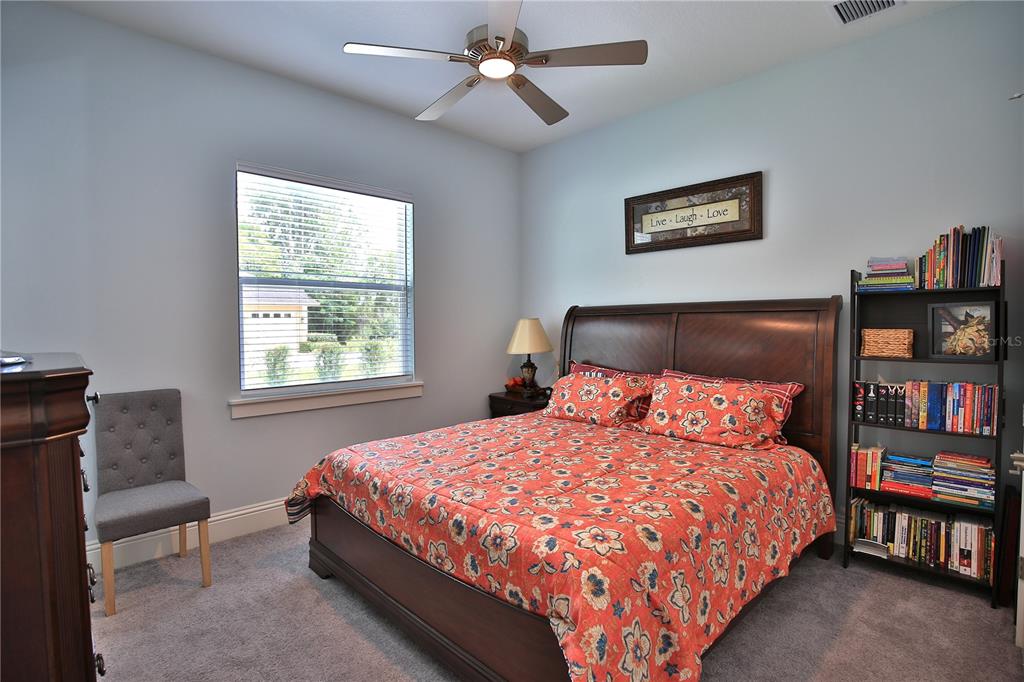 5845 Southwest 43rd St Road Ocala, FL 34474 - Photo 30 of 38 a bedroom with a bed furniture and a book shelf