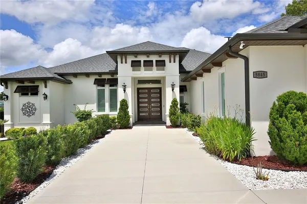a front view of a house with garden