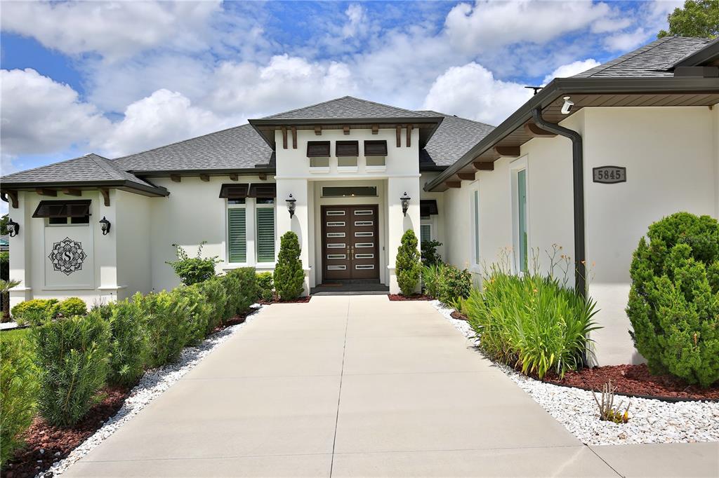 5845 Southwest 43rd St Road Ocala, FL 34474 - Photo 3 of 38 a front view of a house with garden