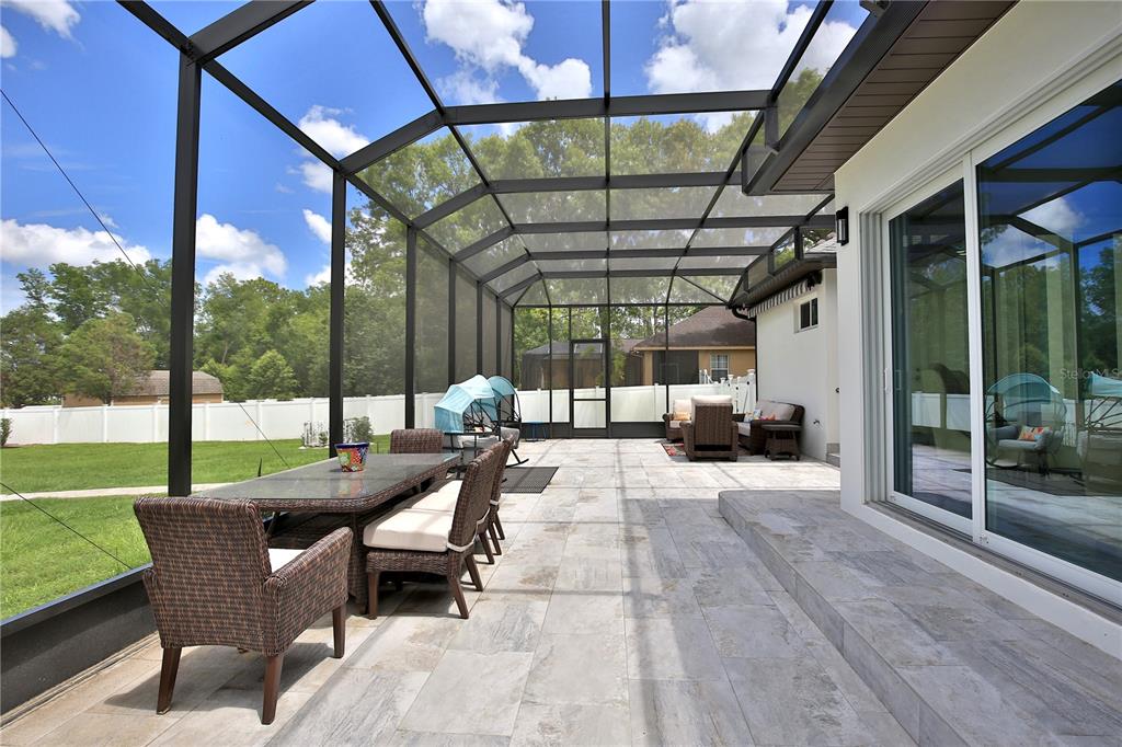 5845 Southwest 43rd St Road Ocala, FL 34474 - Photo 32 of 38 a building outdoor space with patio furniture and garden