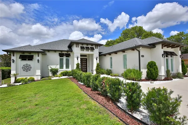 a front view of a house with a garden