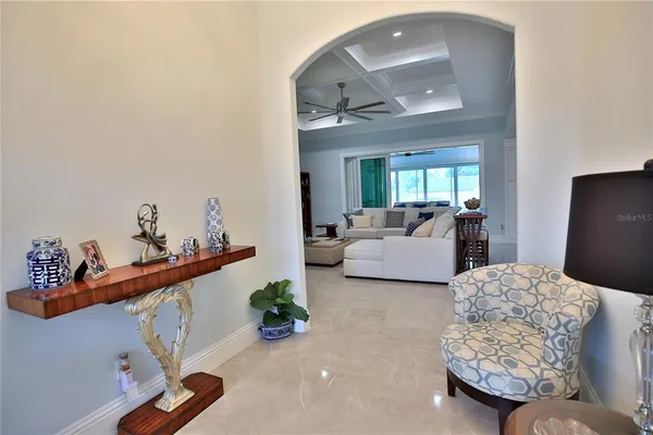 a living room with furniture and a mirror