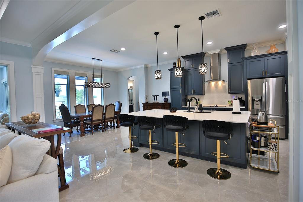 5845 Southwest 43rd St Road Ocala, FL 34474 - Photo 6 of 38 a large kitchen with a table chairs refrigerator and cabinets