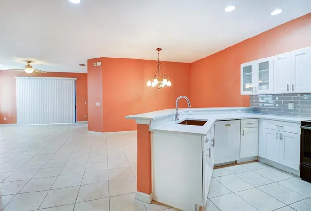 a kitchen that has a sink and a stove top oven