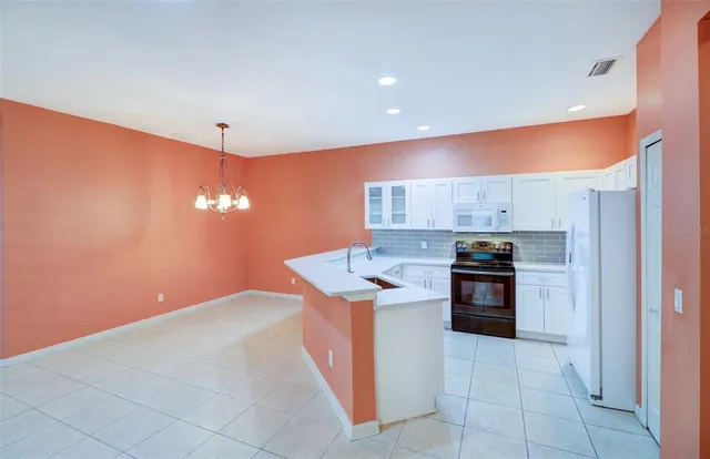 an empty room with a ceiling fan and a window