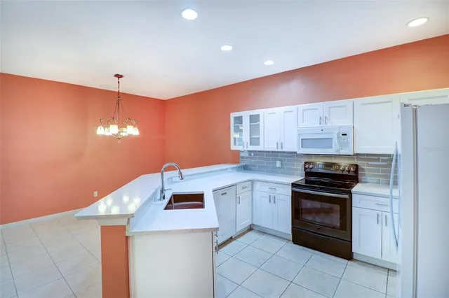 a bathroom with a granite countertop sink a toilet and a bathtub
