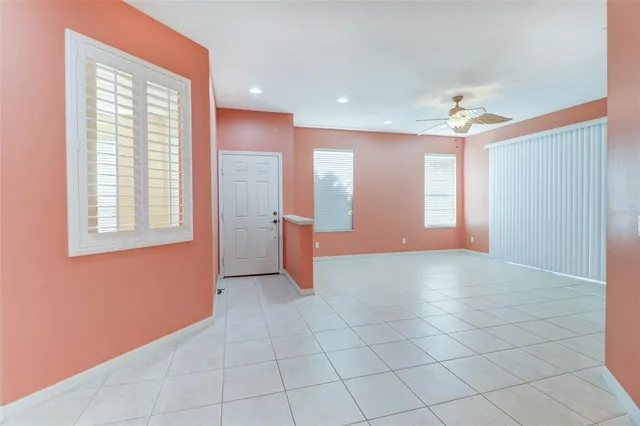 a kitchen with granite countertop a refrigerator and a stove top oven
