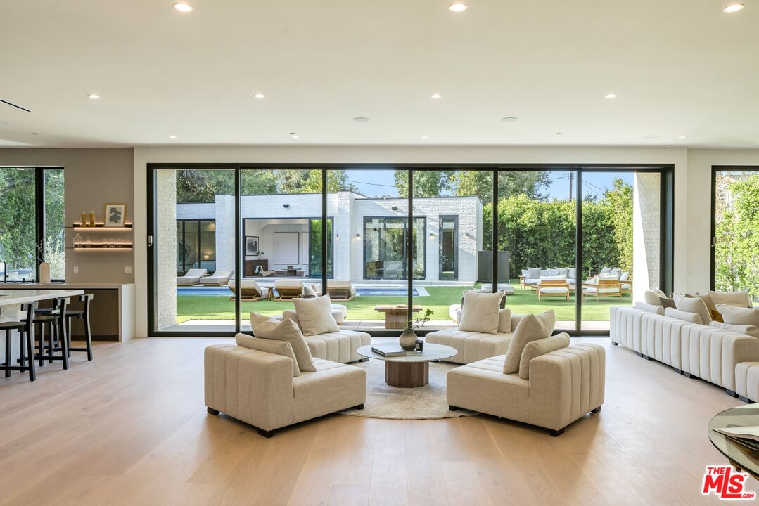 17055 Rancho Street Encino, CA 91316 - Photo 30 of 73 a living room with furniture and a large window