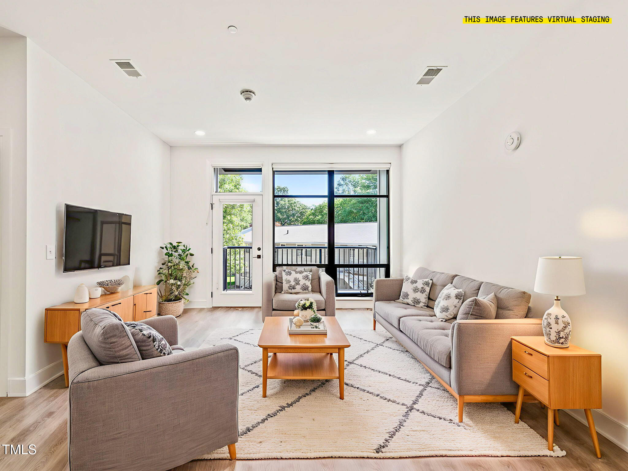 a living room with furniture and a flat screen tv